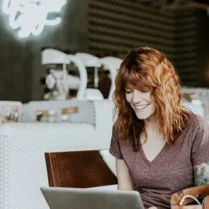 Woman Smiling at Laptop