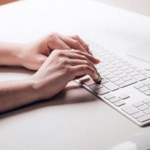 Hands Typing on Keyboard